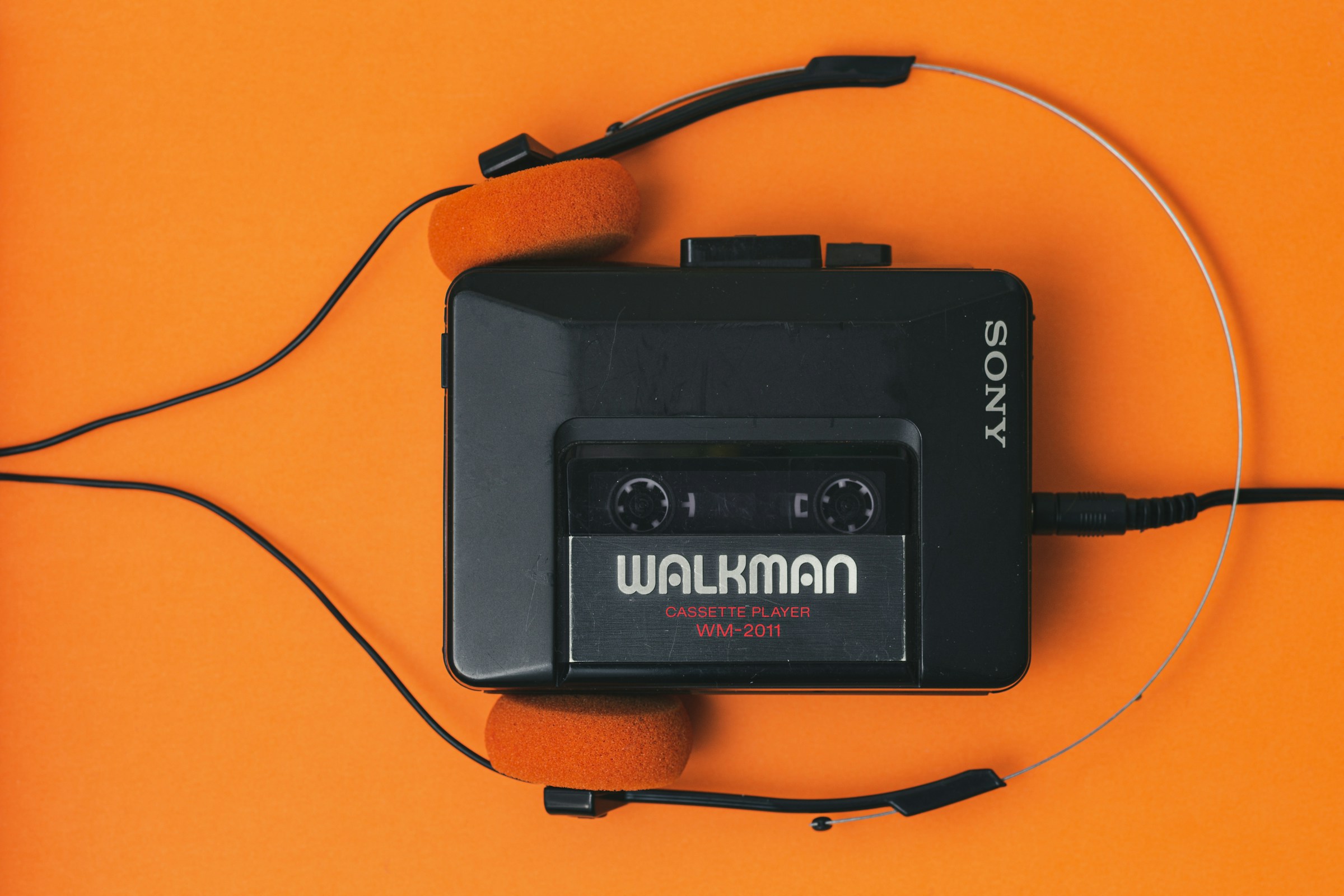 Sony Walkman cassette player with orange foam headphones
