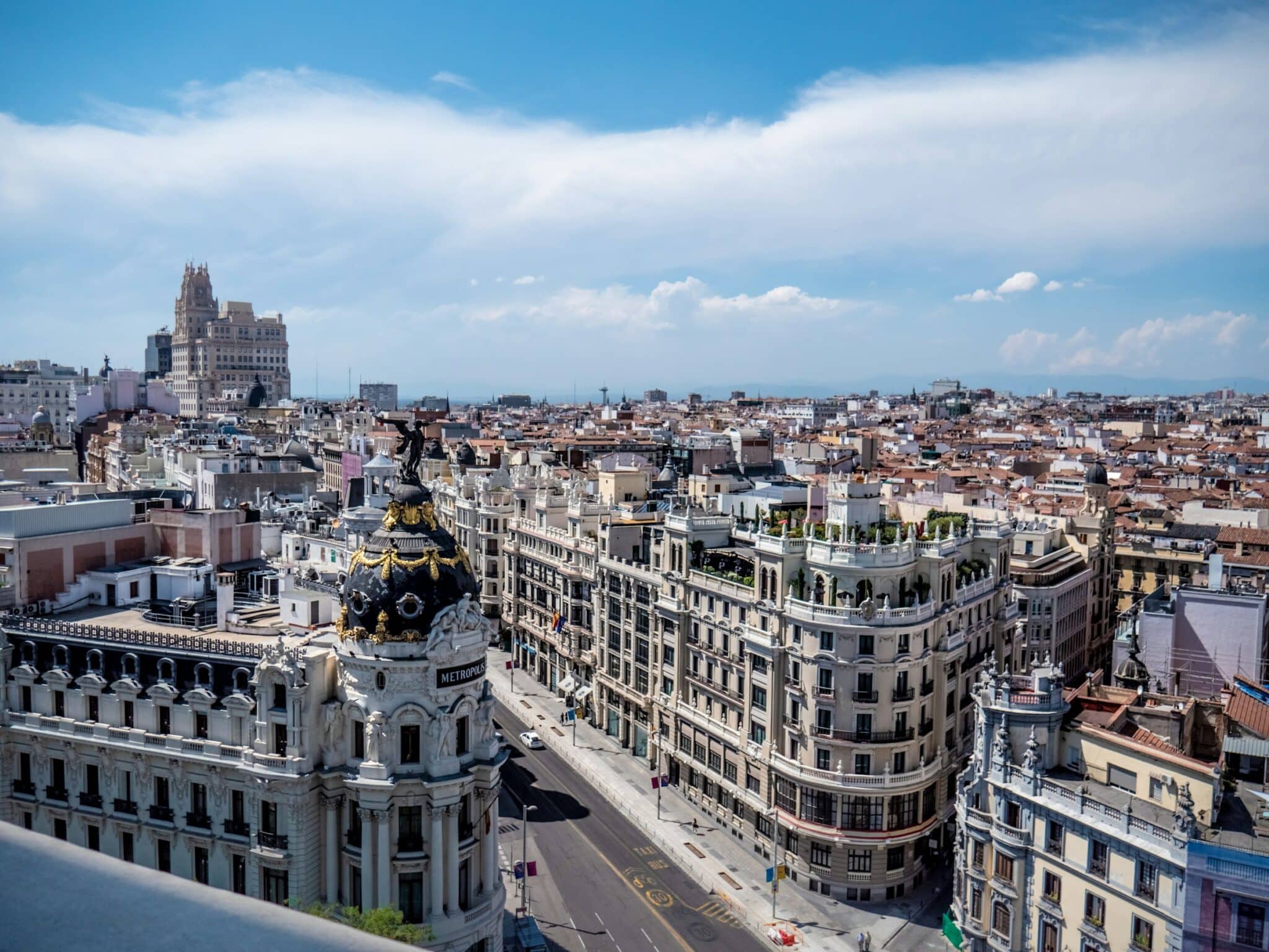 Madrid Gran Via skyline with the iconic Metropolis building under blue sky