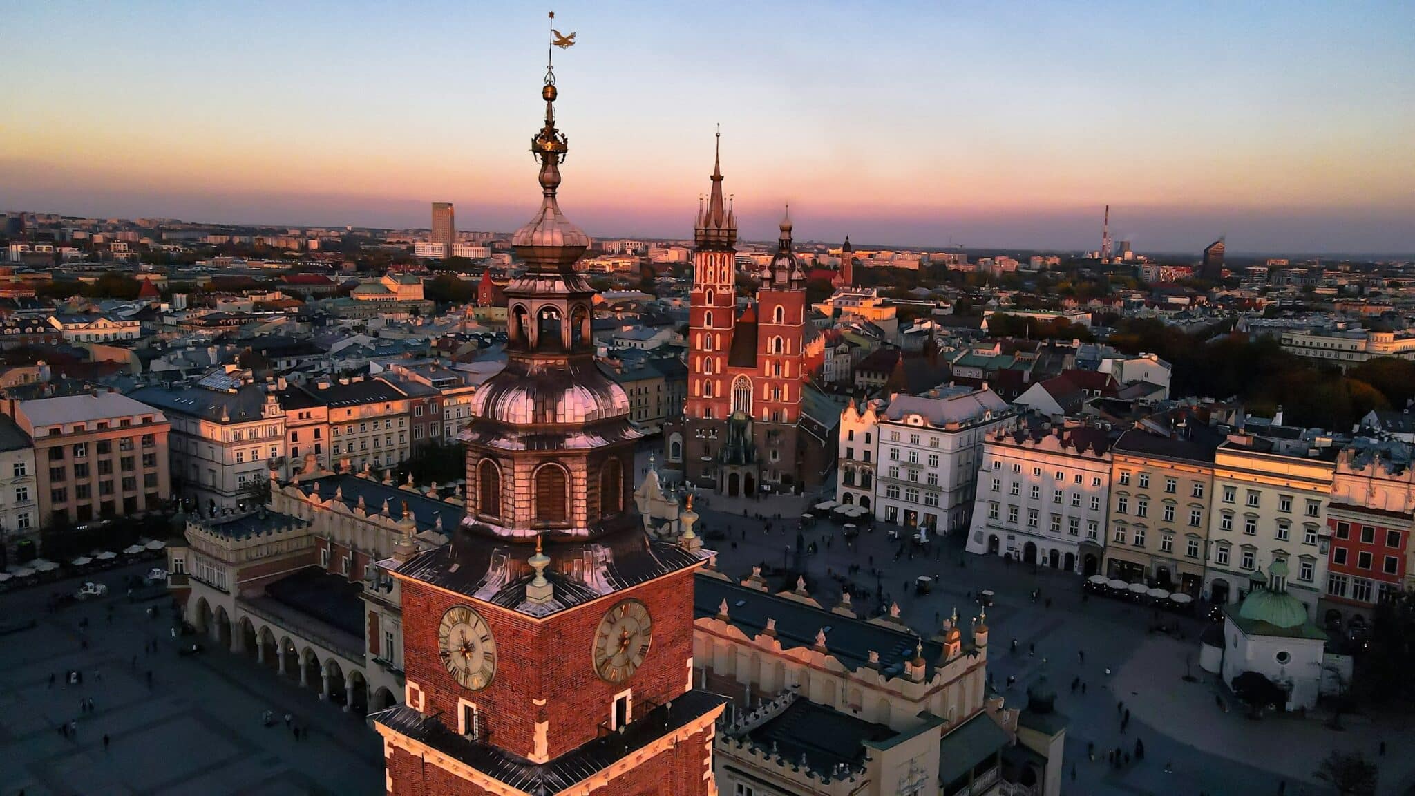 Kraków Main Market Square at sunset, with St. Mary's Basilica and the Cloth Hall.