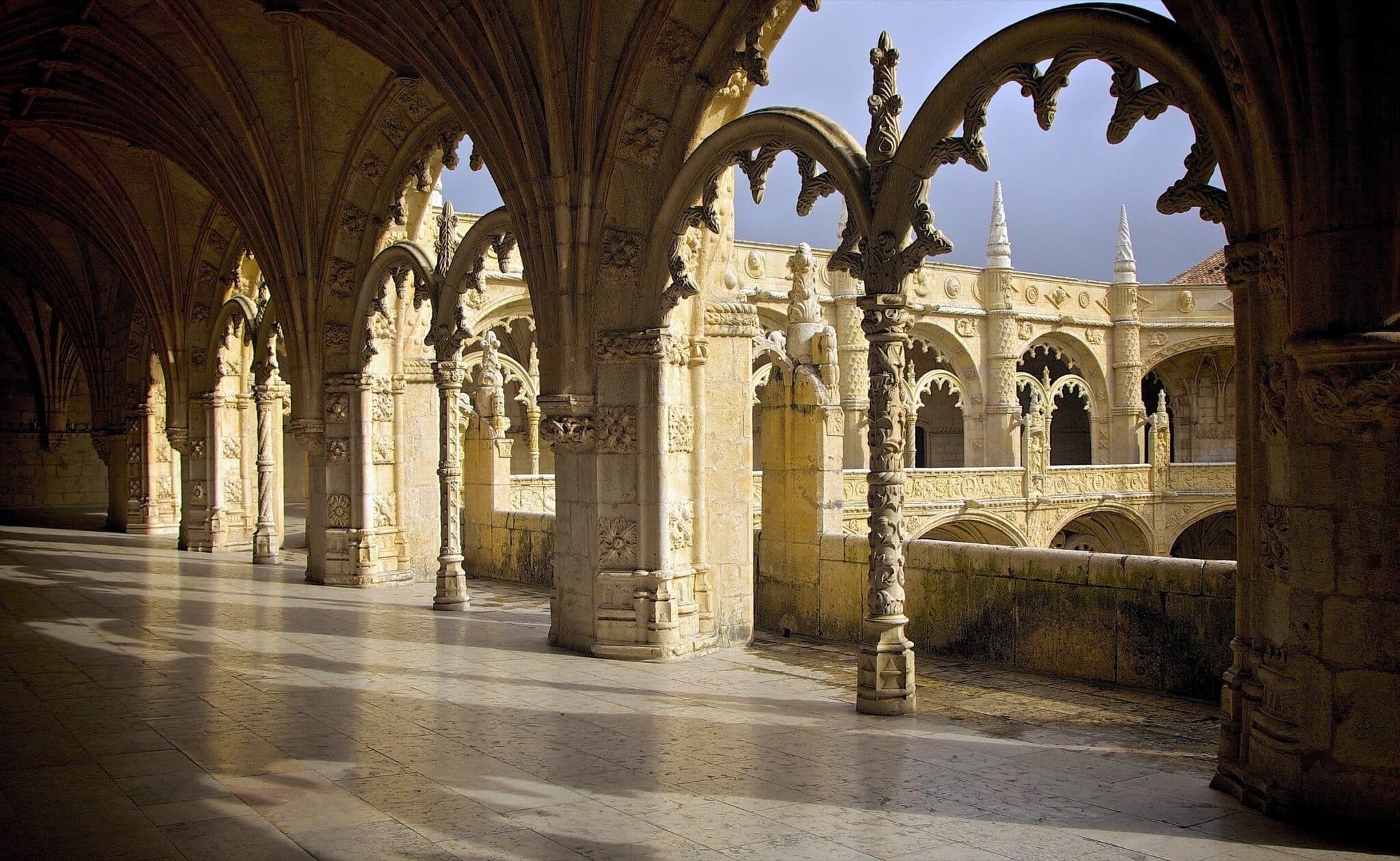 Carved stone arches in the two-storey cloister of the Jeronimos Monastery in Belem