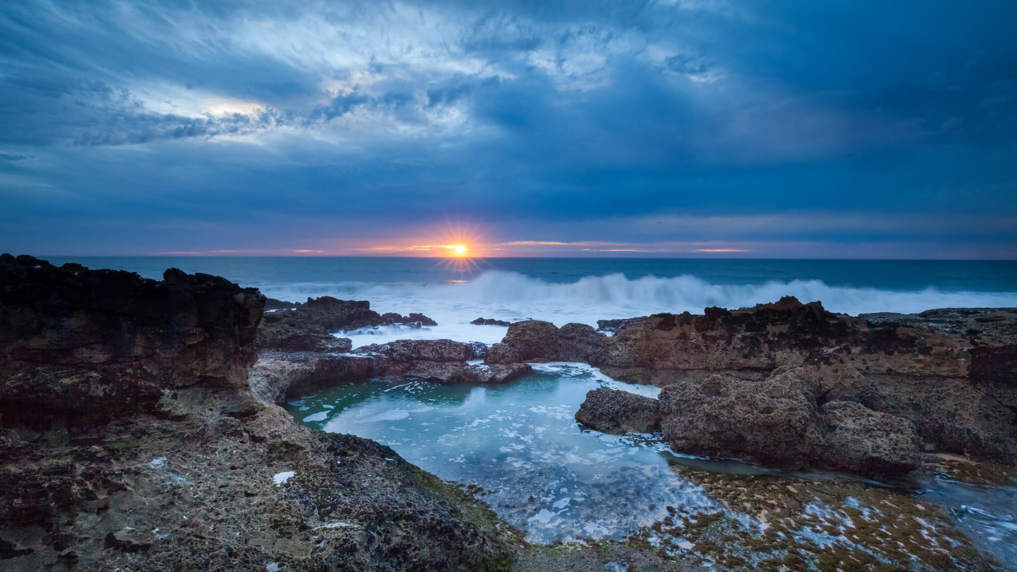 Rocks and tide pools on the Atlantic coast at Guincho near Cascais at sunset